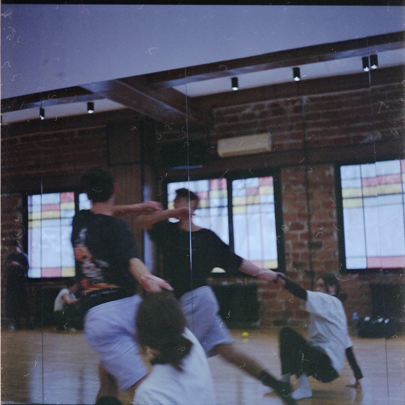 Studio rehearsal on 35mm film, brick and mirrored walls