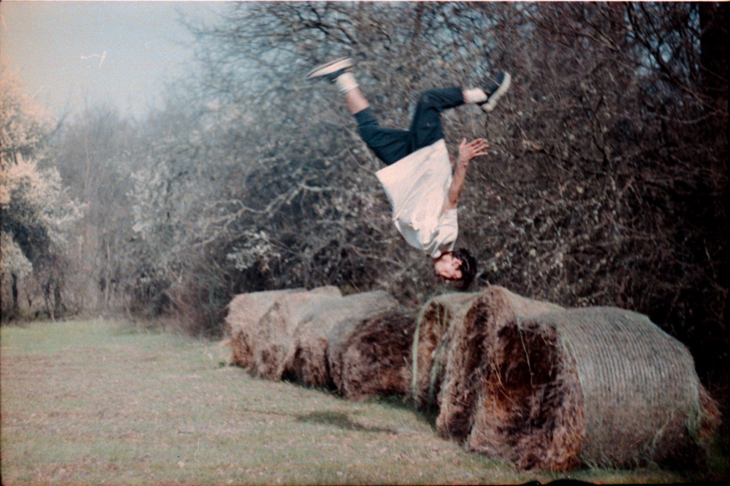 Roman inverted over hay bales, film grain